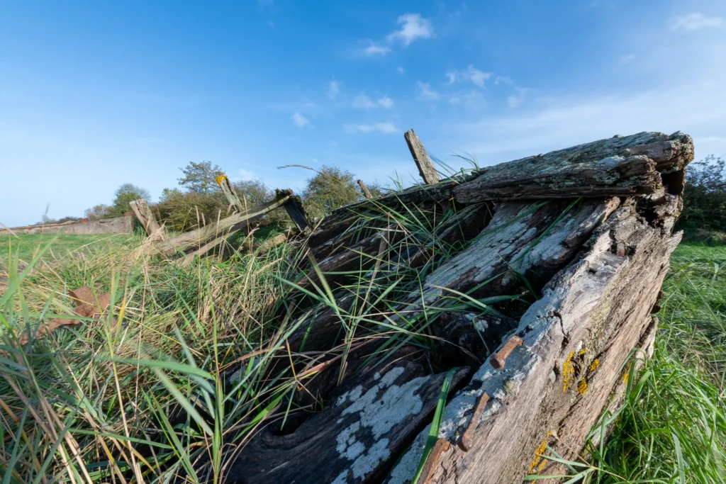 Exploring Decay and Beauty at Purton Ship Graveyard in October purton ship graveyard decaying wooden structure